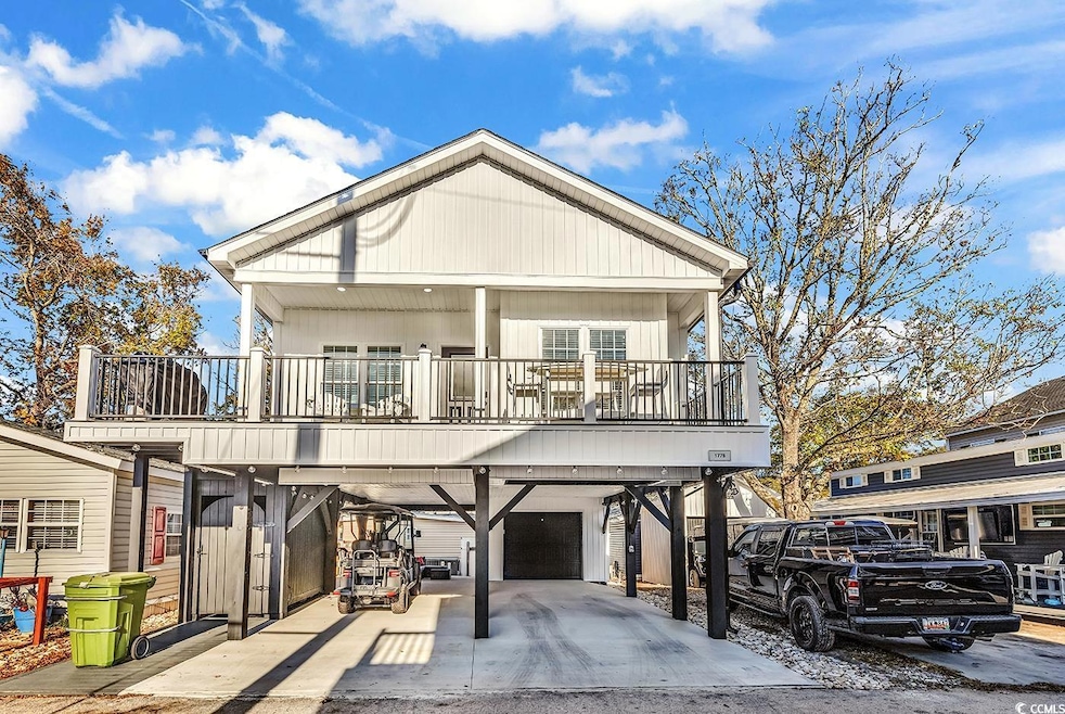 View of front of home with a carport, a garage, co