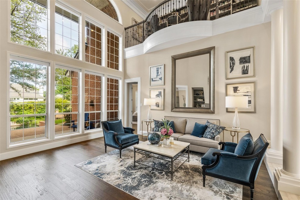 Formal living looking out to pool and canal with loft library nook above.