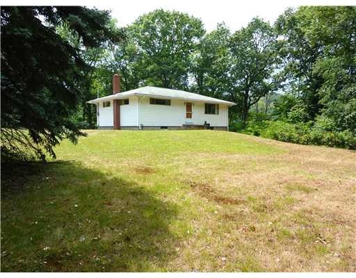Exterior Front. PRIVATE WOODED SETTING.