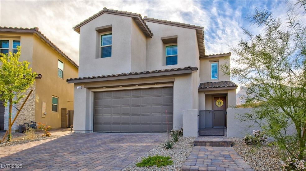 Mediterranean / spanish-style house featuring a ga