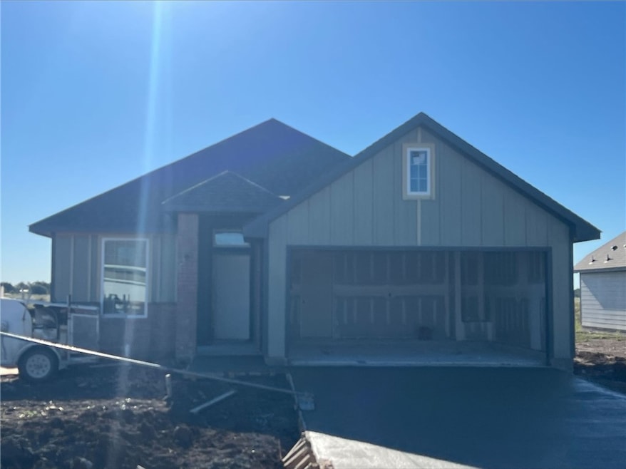View of front facade with board and batten siding and a garage
