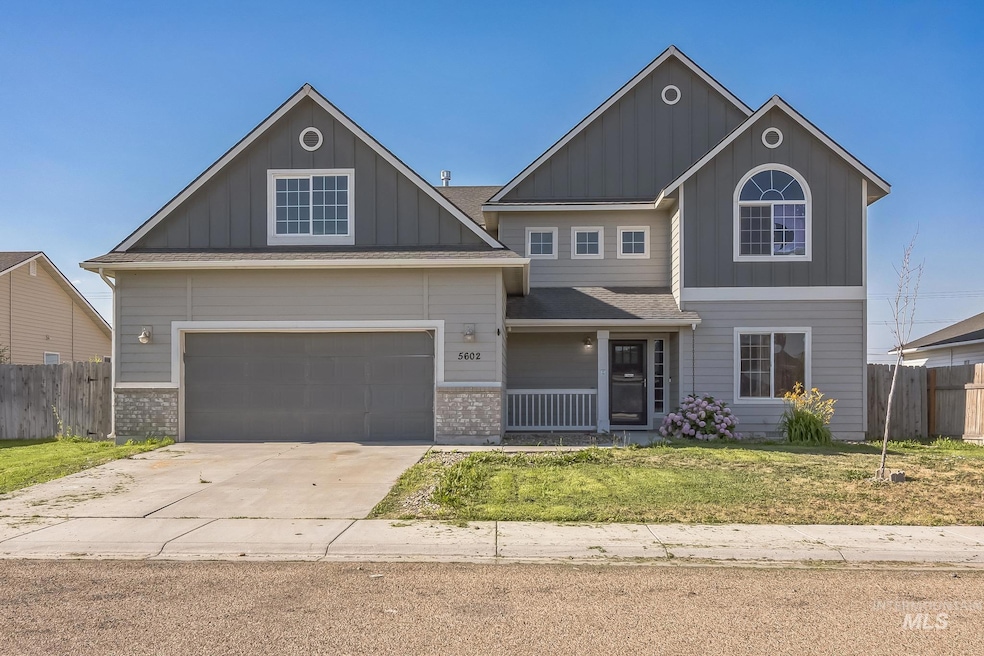 View of front of home featuring board and batten siding, concrete driveway, and an attached garage