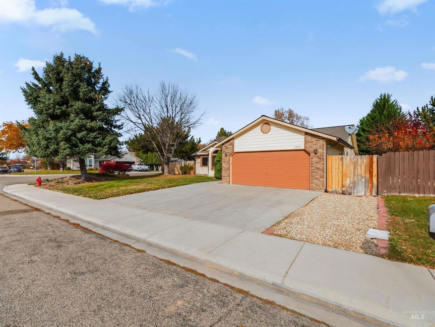 View of front of home with concrete driveway, brick siding, and a garage