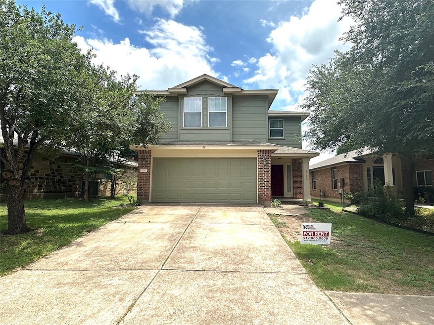 Traditional-style home with driveway, a garage, b