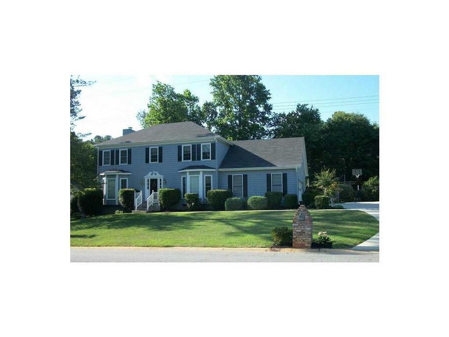 Exterior Front. Well kept lawn and shrubs and bloo