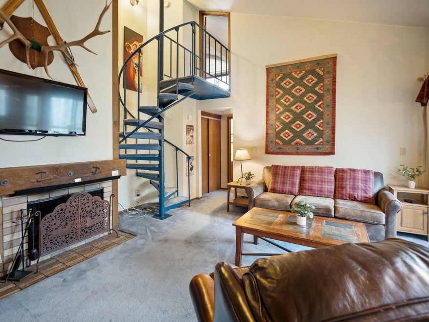 Carpeted living room featuring high vaulted ceilin