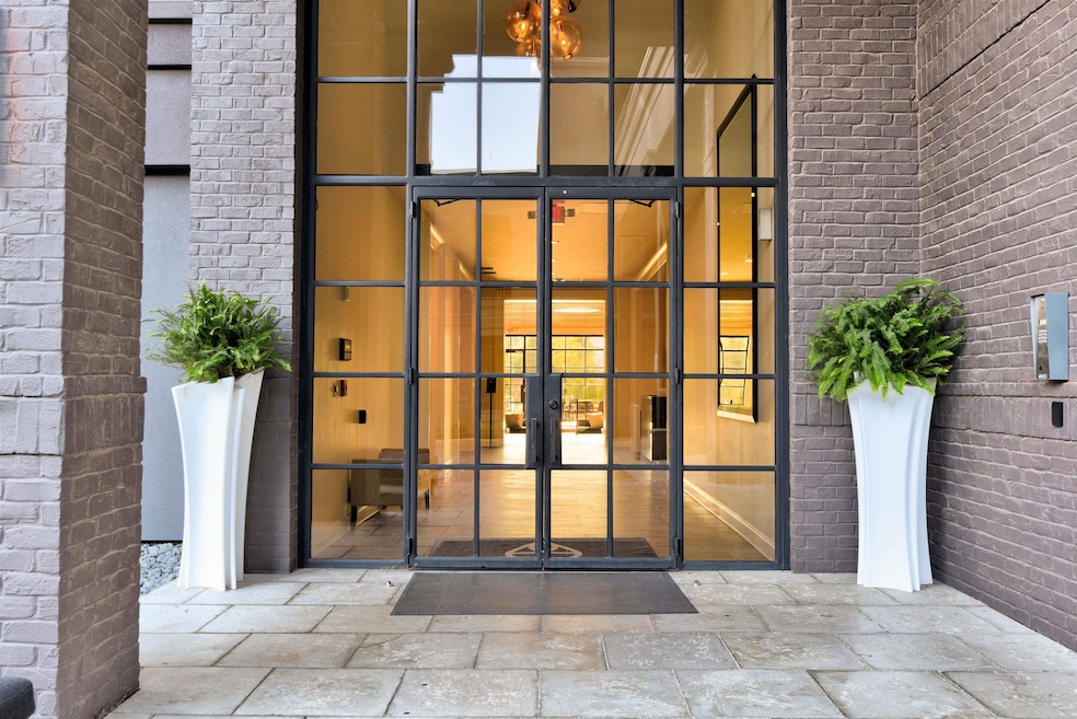Doorway to property featuring brick siding and fre