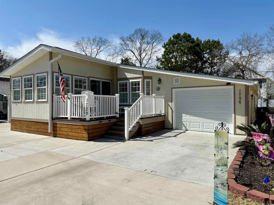 View of front of home with an attached garage and driveway