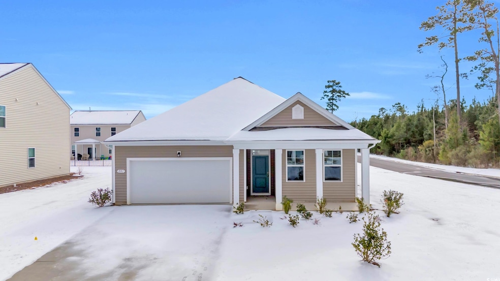 View of front facade featuring a garage