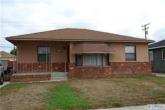 FRONT OF HOME W/ PORCH AND SHARED DRIVEWAY.
