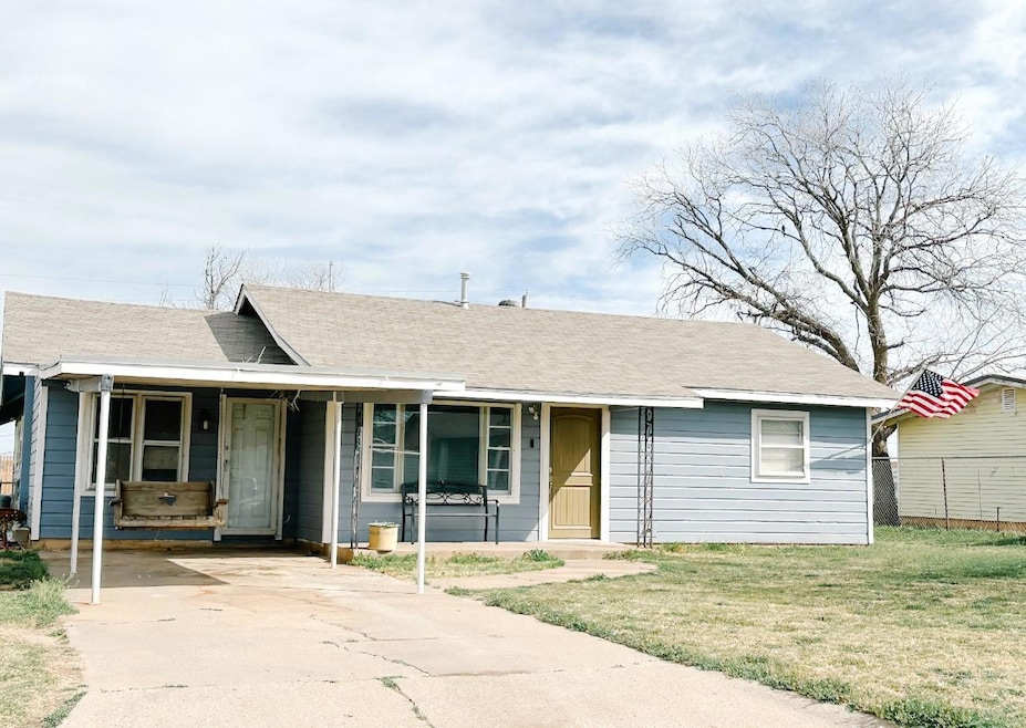 View of front facade with an attached carport, a f