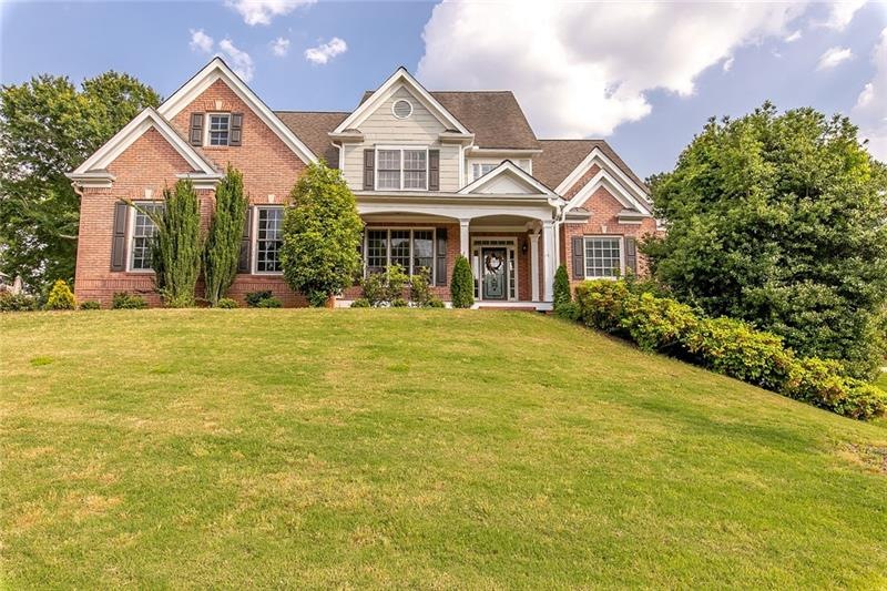 Welcome home! This beautiful 3 sided brick traditi