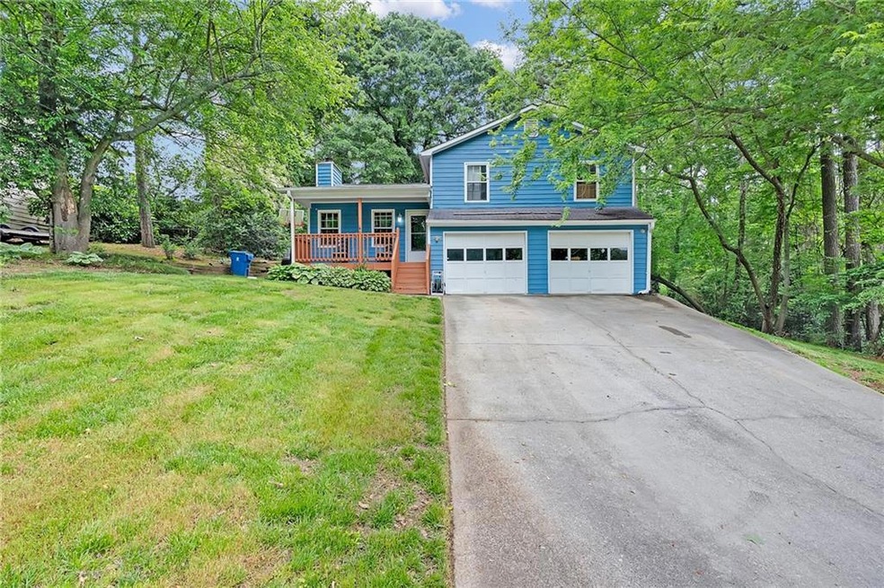 Split level home with a porch, concrete driveway, 
