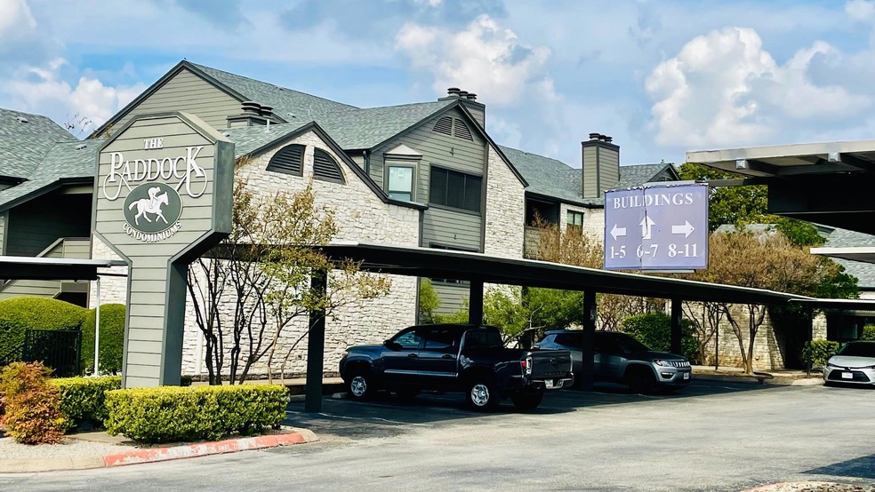 Covered parking lot featuring a residential view