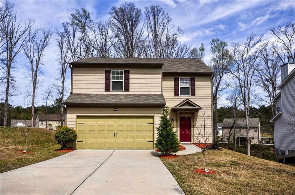 View of property with a front yard and a garage