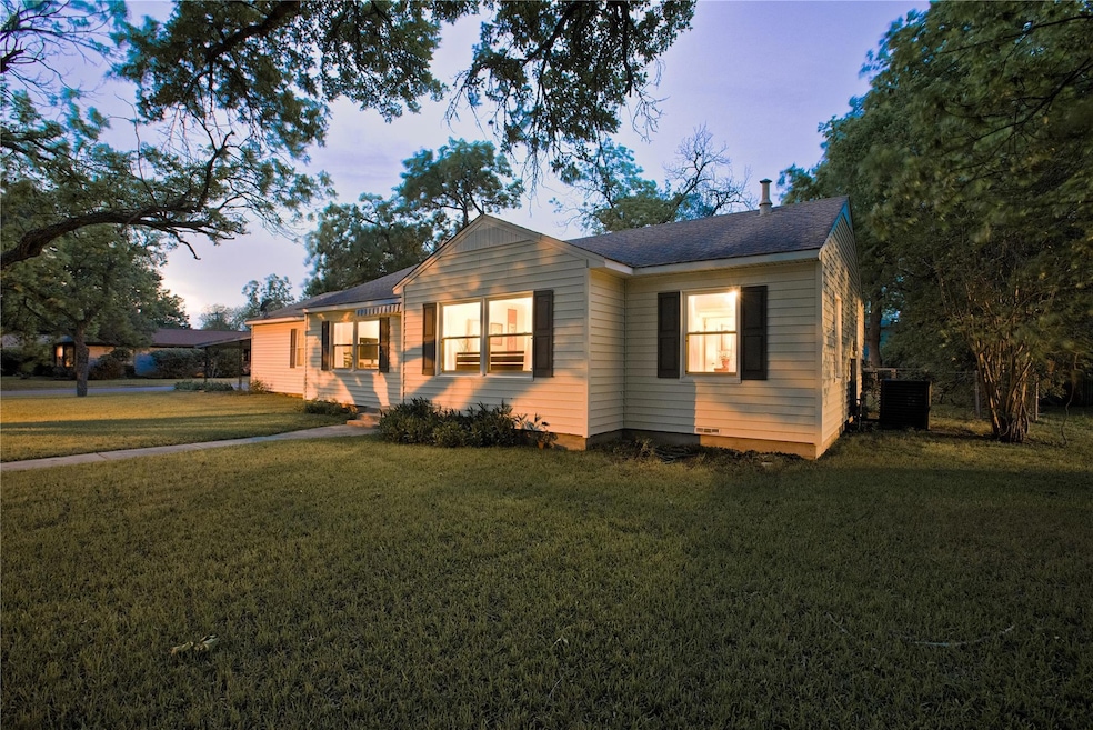 Bungalow-style house with central AC unit, a fron