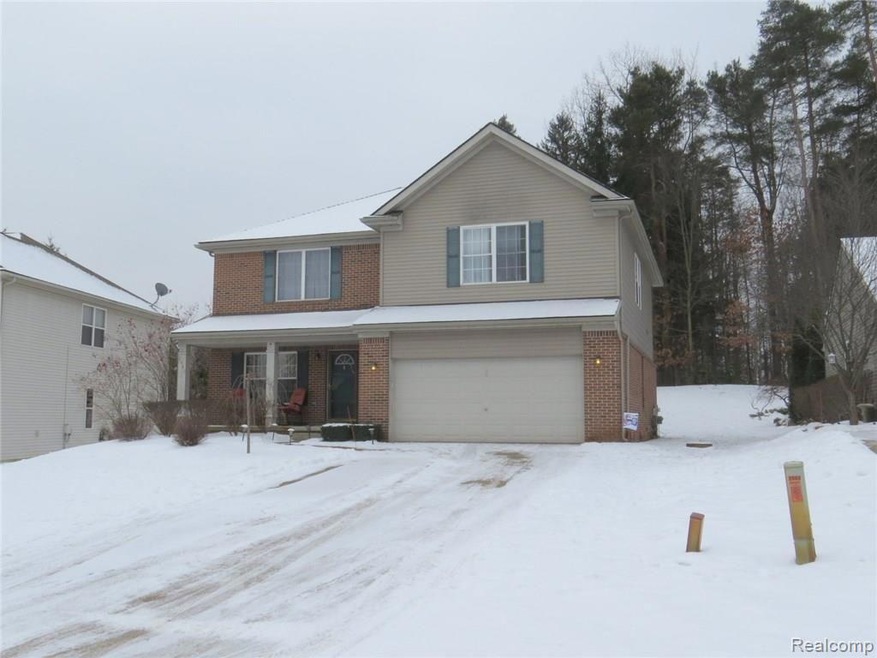 Front view of home, note trees behind, and under t