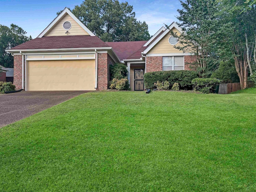 Ranch-style home featuring driveway, brick siding, a front lawn, and a garage
