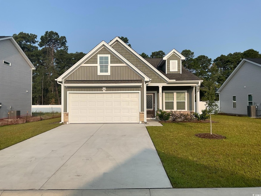 Craftsman-style house featuring a front lawn, a ga