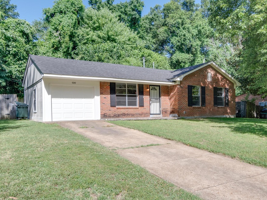 Single story home featuring a garage and front yar