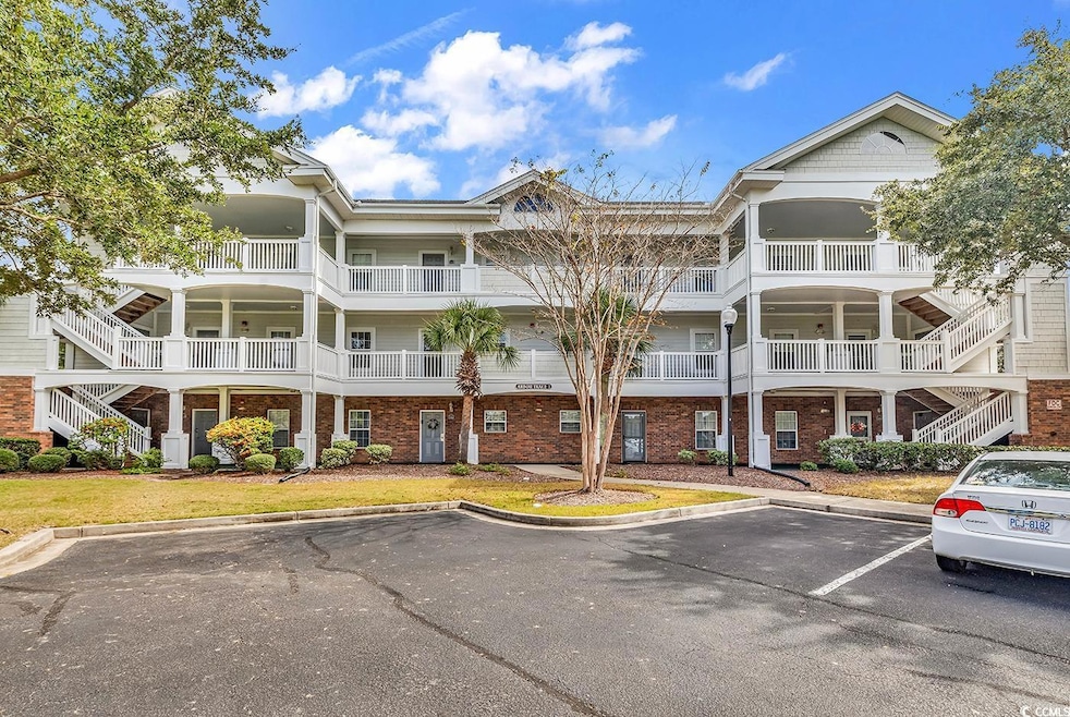 View of property featuring uncovered parking