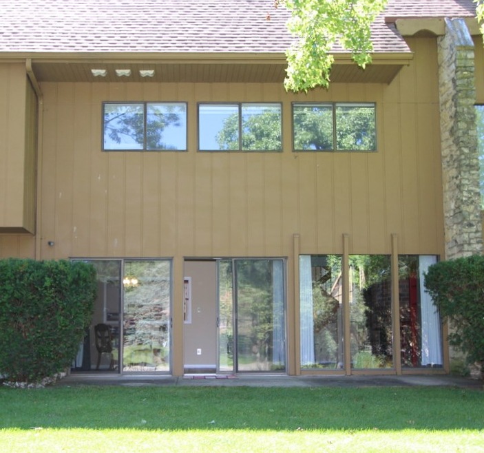 View of the sliding glass doors to the shaded pati