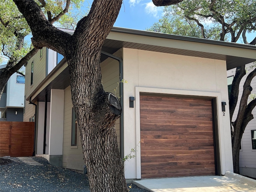 View of property exterior featuring a garage, fen