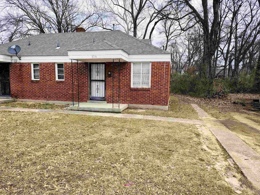 View of front of house with brick siding, a chimne