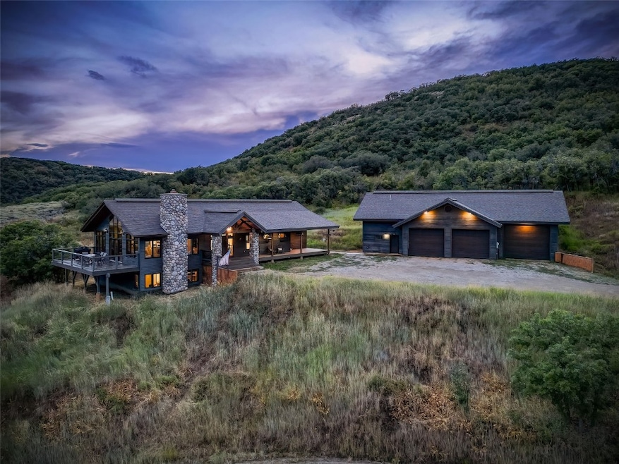 View of front of property with a garage and a moun