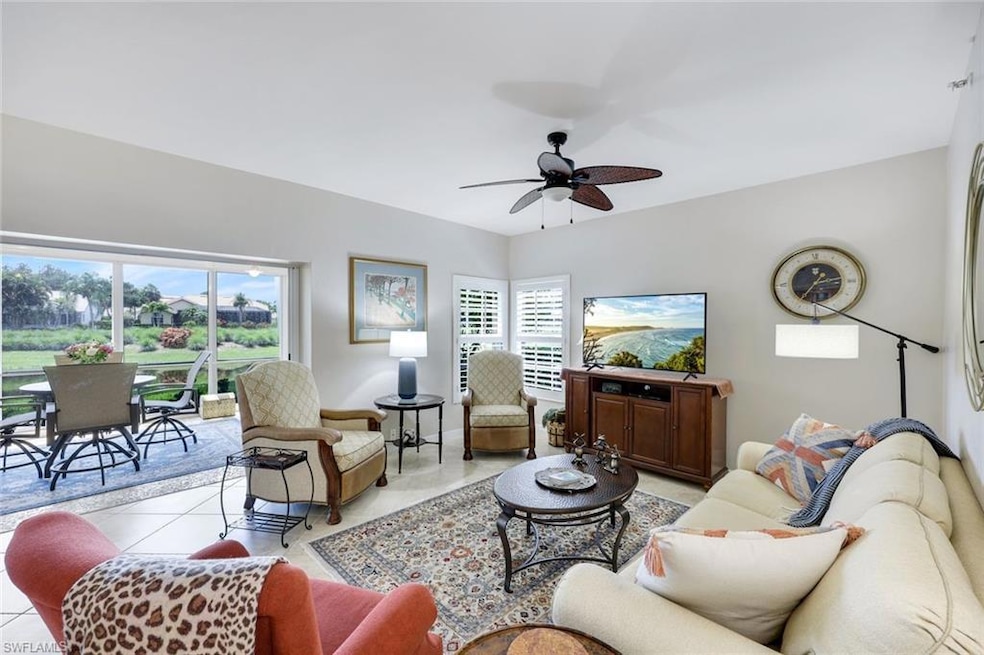Living room featuring healthy amount of natural light, ceiling fan, and light tile patterned flooring