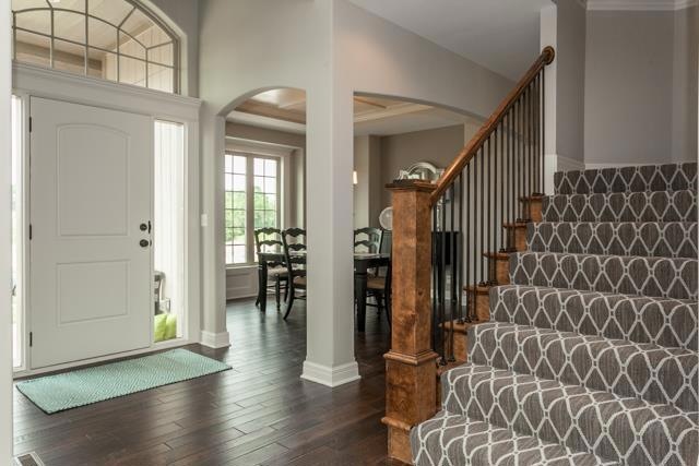 Entry with Hardwoods and Lovely Staircase with Sta