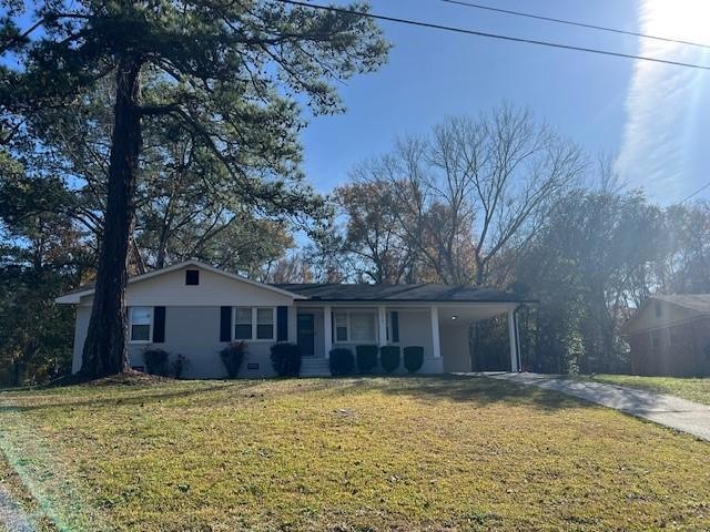 Single story home with a carport and a front lawn