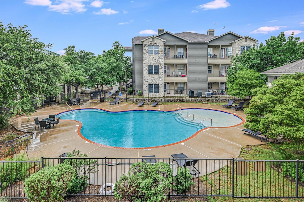Community pool with fence and a patio area