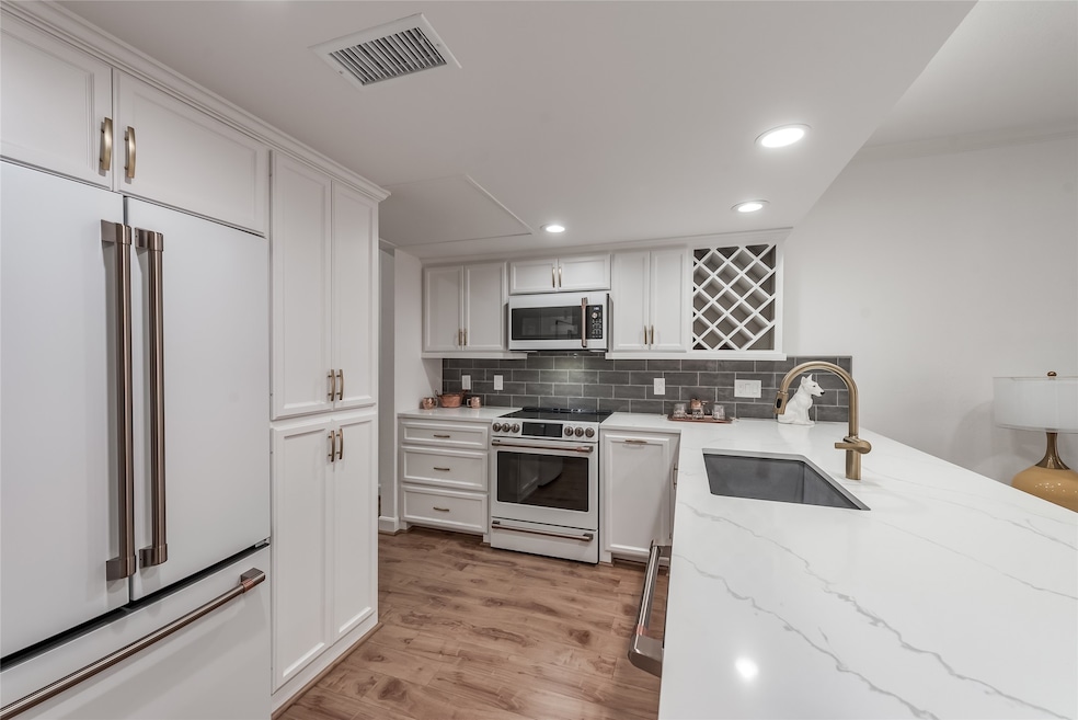 New kitchen with CAFE GE appliances and bronze han