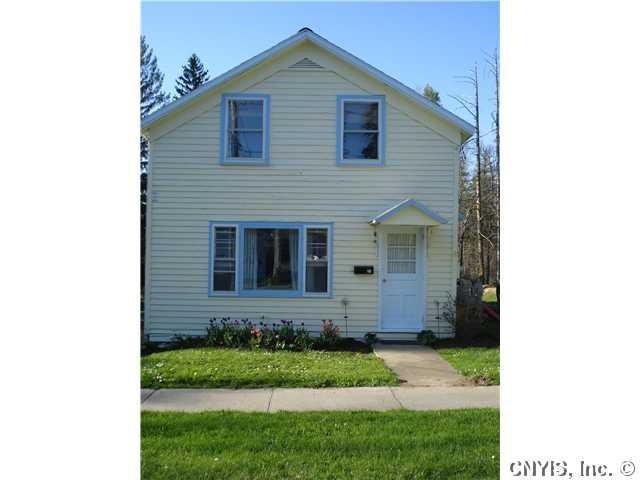 Exterior Front. Beautiful flowers adorn this adora