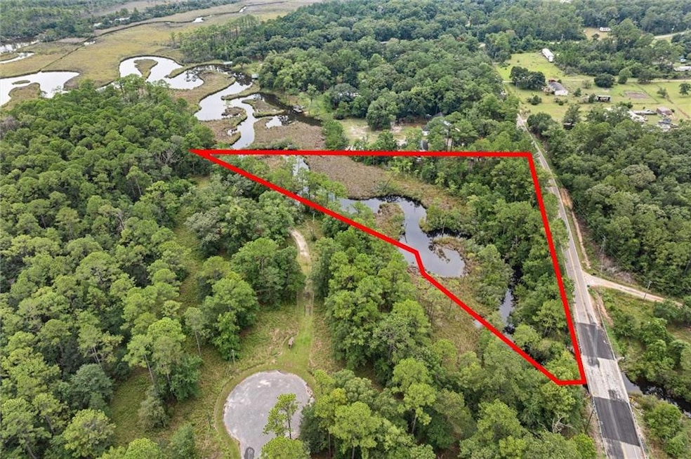 Aerial view of property's location featuring a large body of water and property parcel outlined
