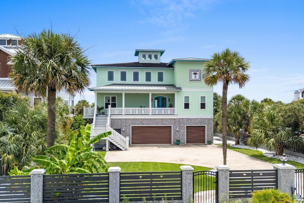 Coastal inspired home with stairs, a balcony, driveway, a metal roof, and a fenced front yard