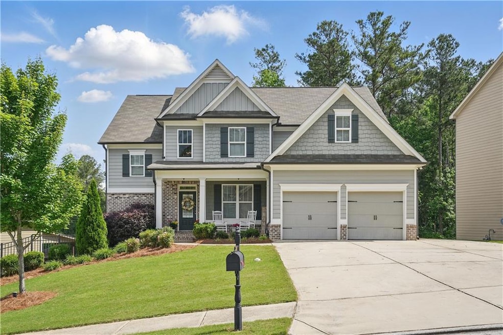 Craftsman inspired home with brick siding, covered