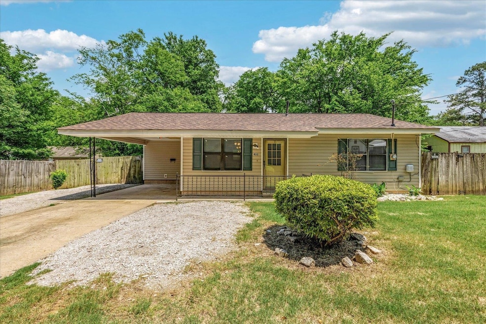 Ranch-style house with driveway, a carport, a porch, and a shingled roof