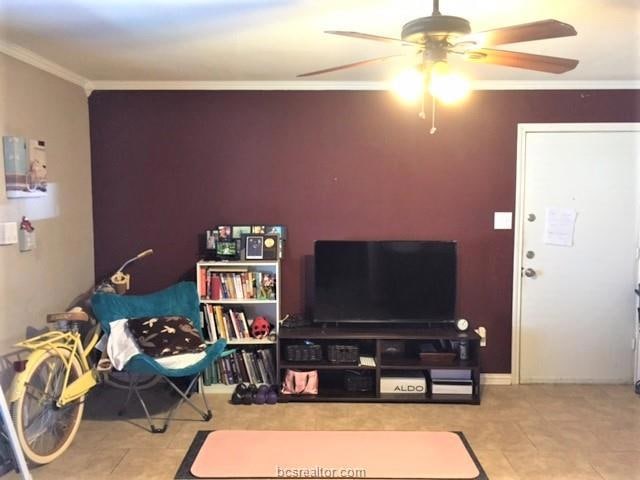 Living room featuring a ceiling fan, tile patterne