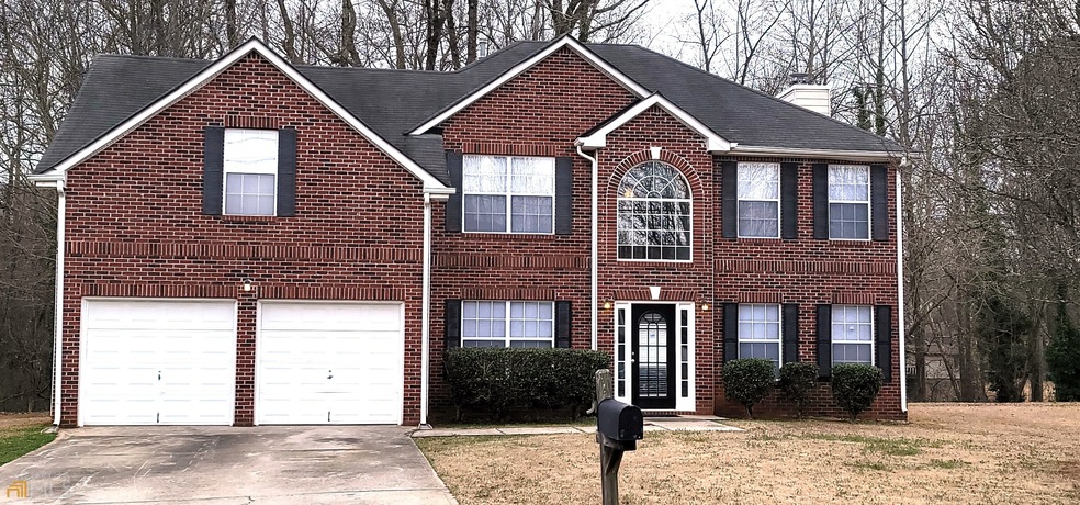 Brick front with 2 car garage and ample parking