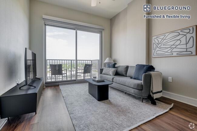 Living area with dark wood-type flooring, ceiling
