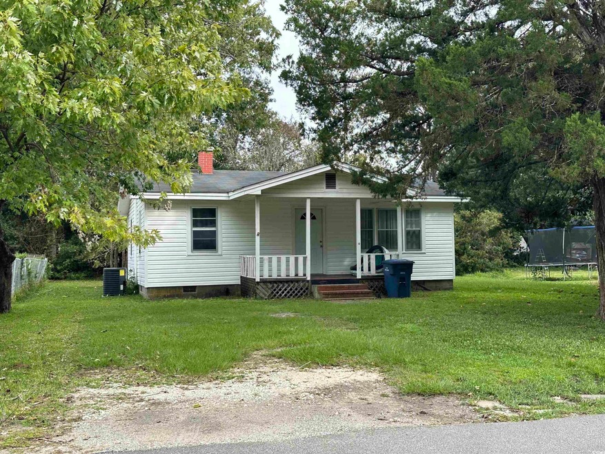 View of front of home featuring a front lawn, cent