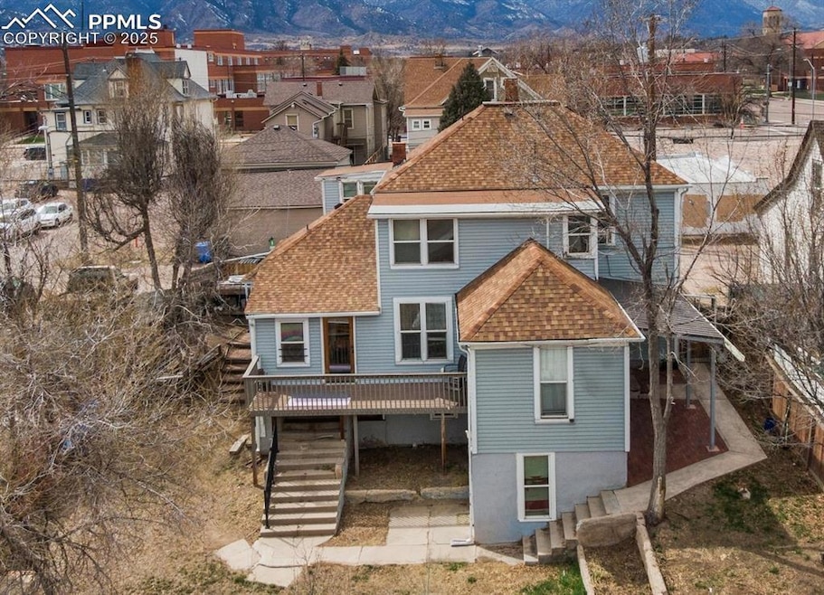 Rear view of house with a deck with mountain view,