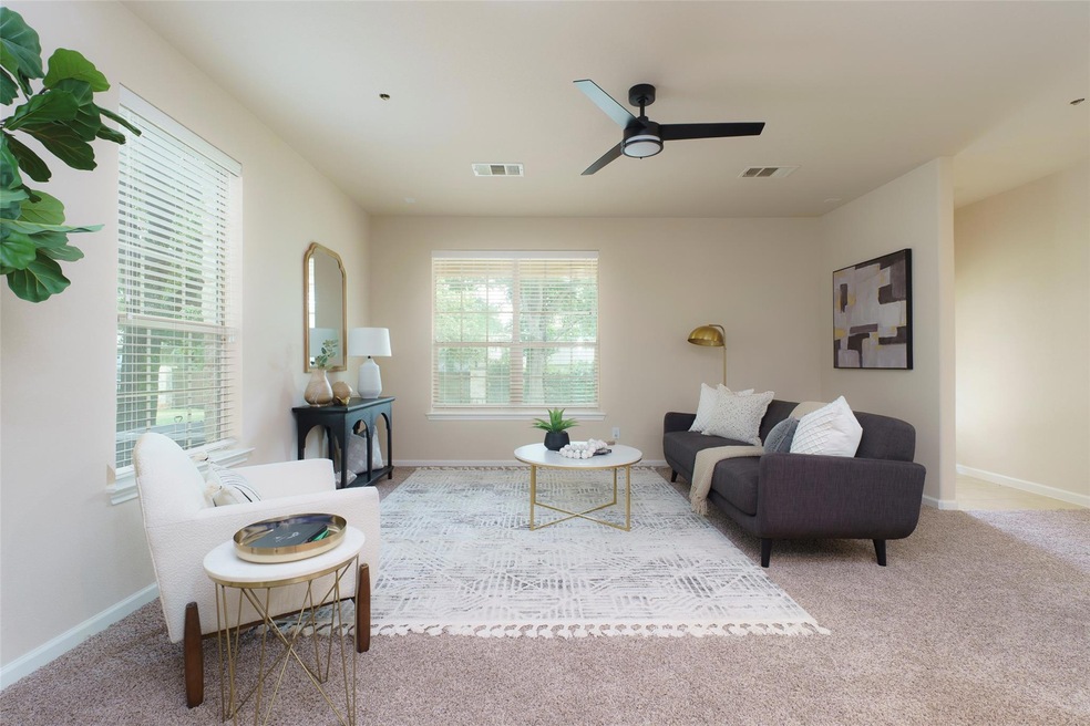 Living room featuring ceiling fan, baseboards, vi