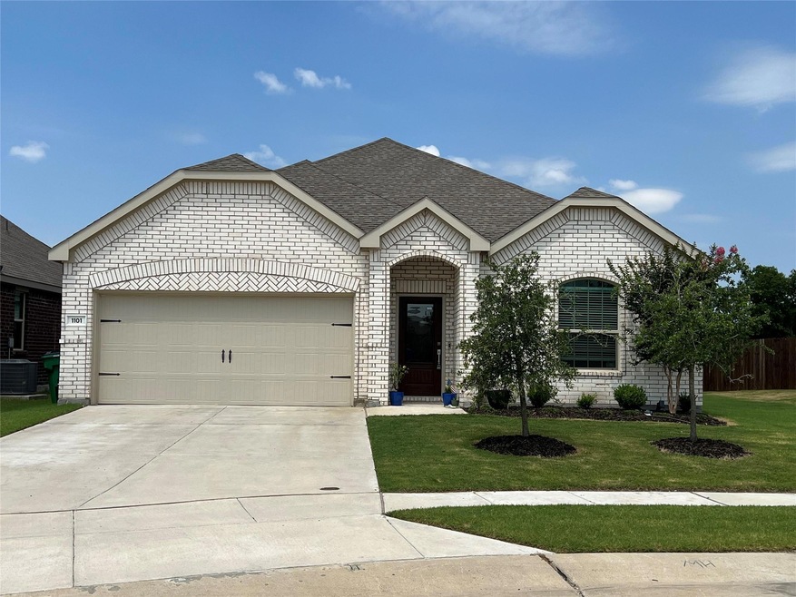 View of front of property featuring a front lawn, a garage, and central AC unit