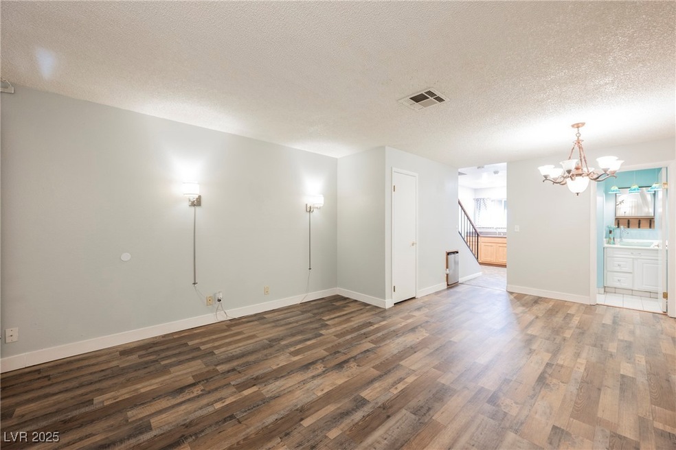 Spare room with visible vents, dark wood-type floo