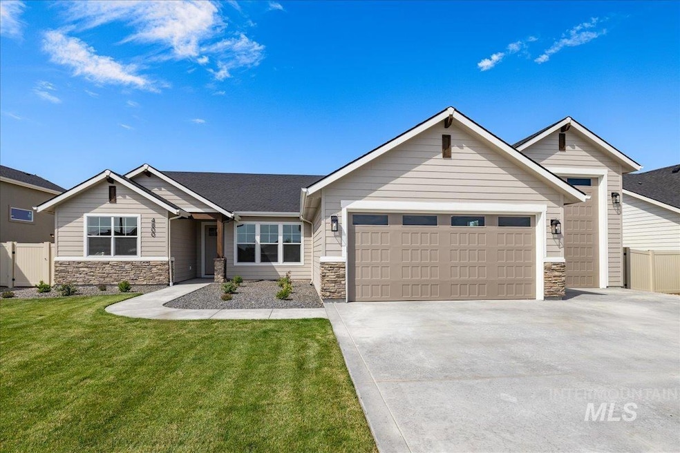 View of front of house with stone siding, an attached garage, driveway, and roof with shingles