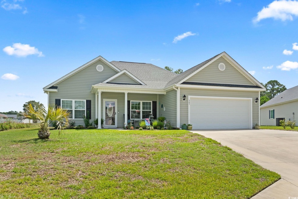 View of front facade with a garage and a front law