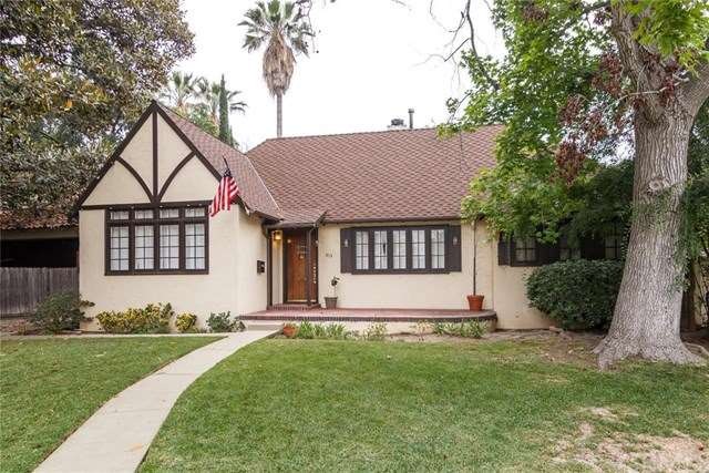 Front of home with front porch and wood door.